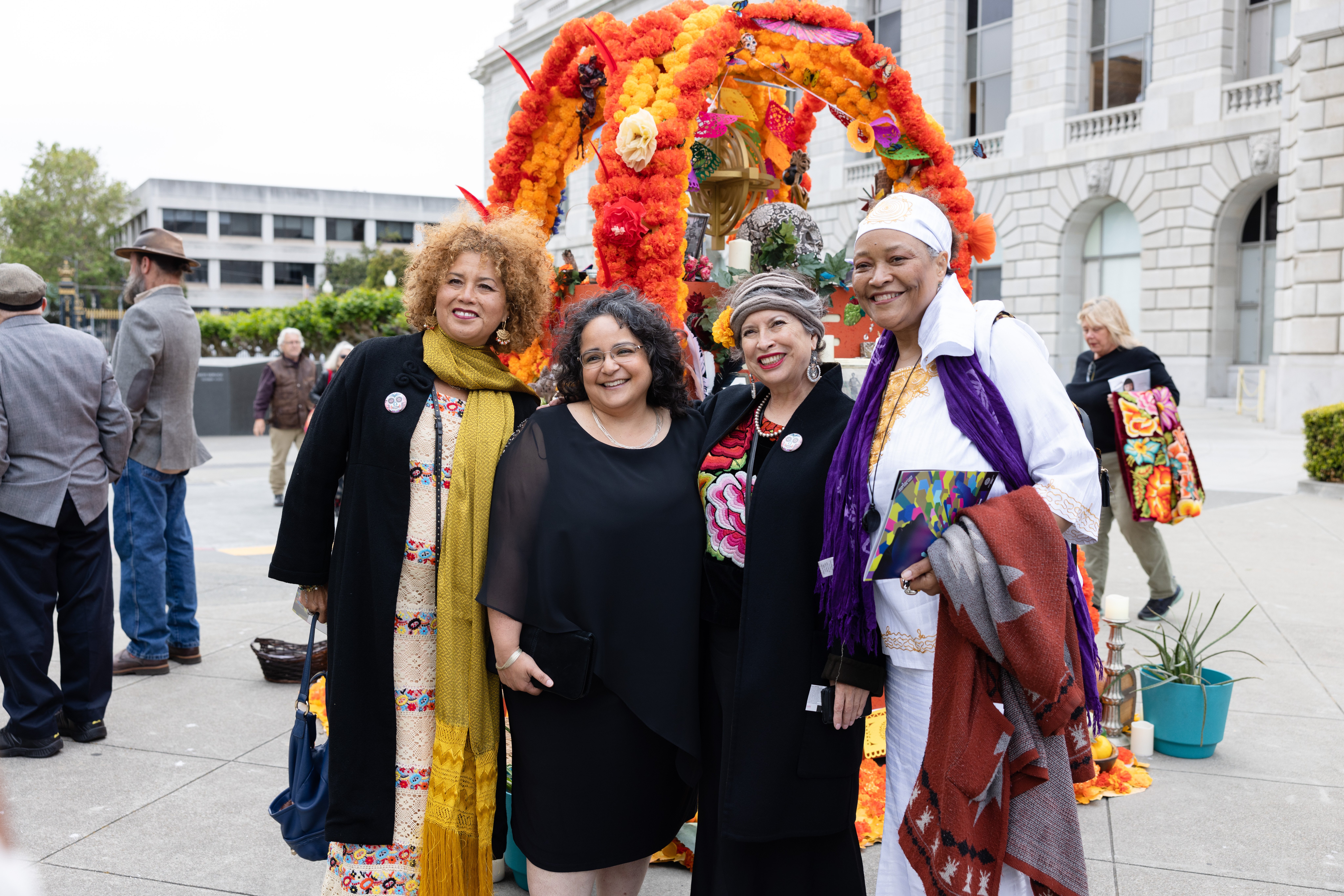 four women posing in front of alter