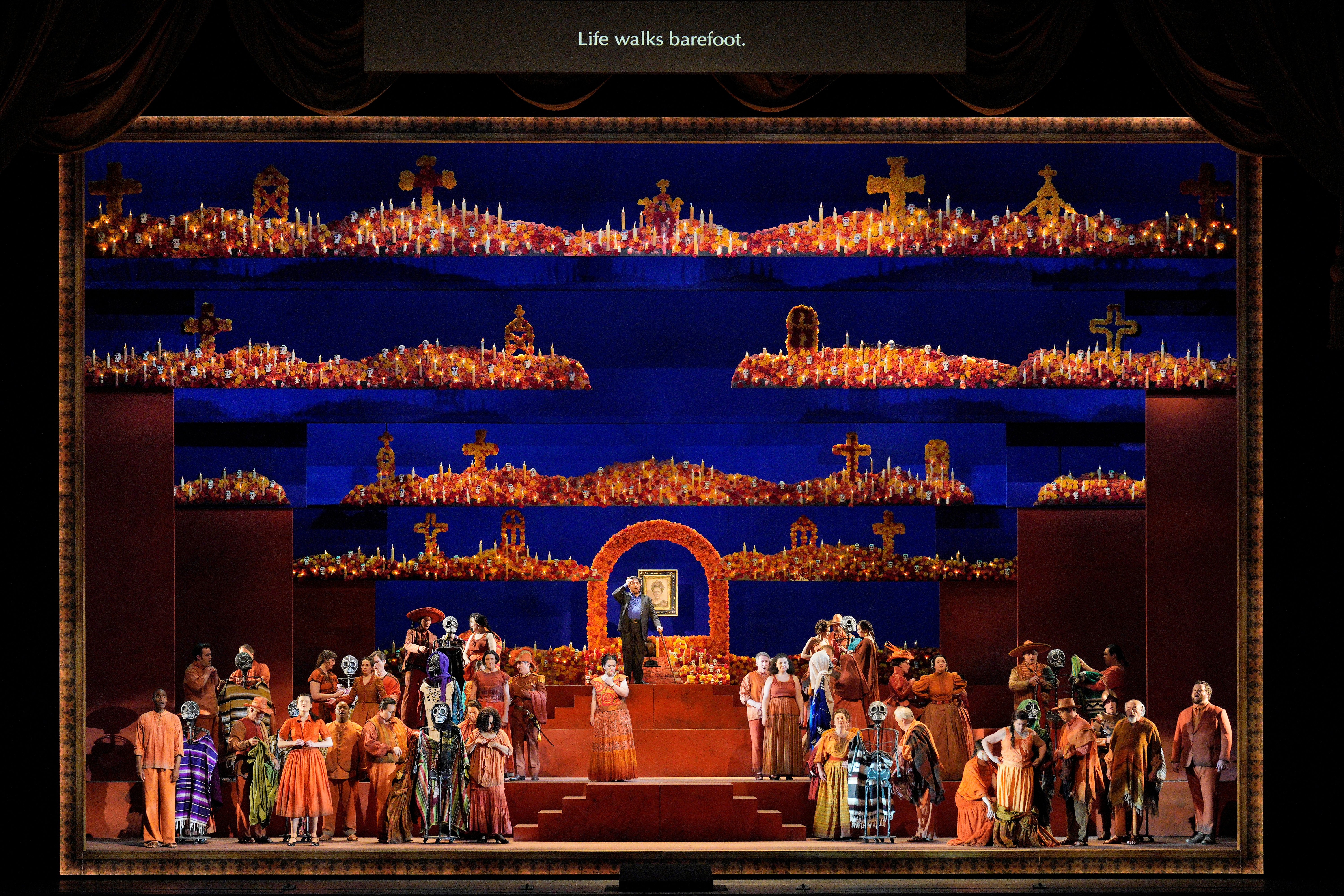 Scene from Frida of stage set with a large number of people on stage 