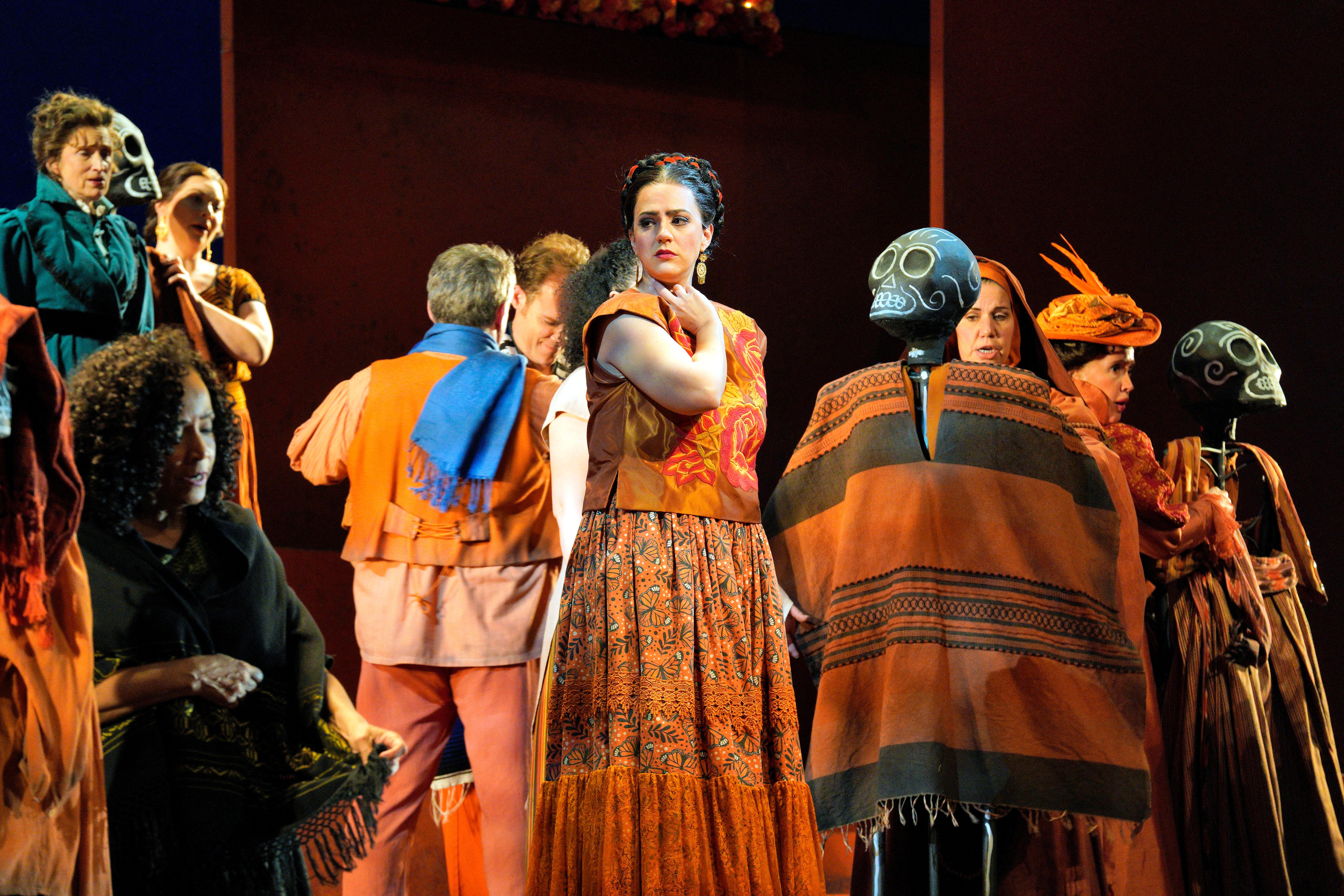 Scene from Frida A group of people dressing up skeletons on stage.