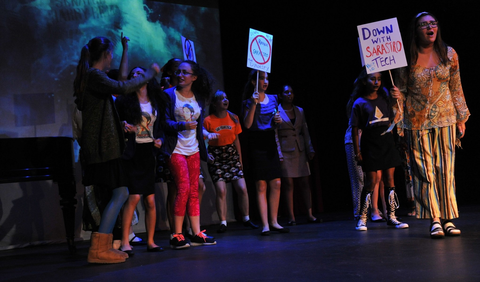 students protesting with signs that say "Down with Sarastro Tech"