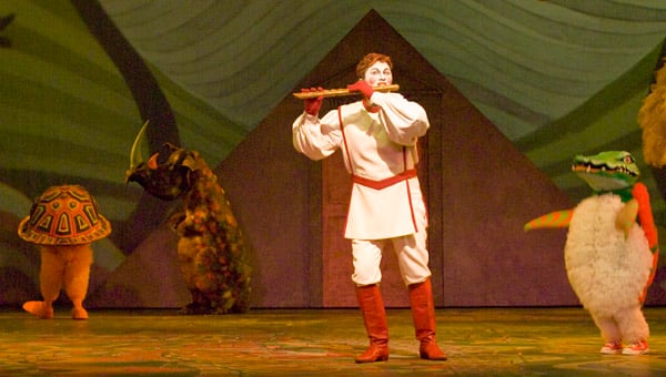 The Magic Flute Opera with person playing flute to animals on stage